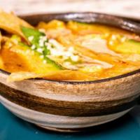 Tortilla Soup · With earthy chunky vegetables, shredded roasted chicken, avocado, tortilla strips, and queso...