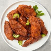 Blazing Hot Wings · Fresh chicken wings fried until golden brown, tossed in hot sauce.