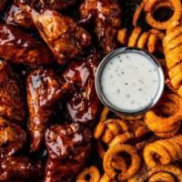 16 Bone-In Wings · 16 bone-in wings tossed in your choice of 2 flavors. Served with curly fries & a side of ran...