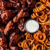 32 Bone-In Wings · 32 bone-in wings tossed in your choice of 4 flavors. Served with curly fries & a side of ranch
