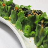 Vegetable Dumpling (5) · Steamed dumplings mixed with edamame, spinach, corn, carrots in a vegetable wrapper & served...