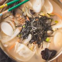 Rice Cake And Dumpling Soup · 떡만두국. Homemade, thinly sliced, and perfectly cooked rice cake and pork dumplings topped with...