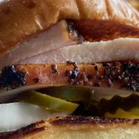 Smoked Turkey Sandwich · Slow smoked turkey between butter griddled buns. pickles onions and sauce served on the side.