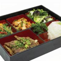 Grilled Marinated Ribs (La Galbi) Box · LA Galbi - grilled beef ribs marinated in a savory sauce, garnished with green onions and se...