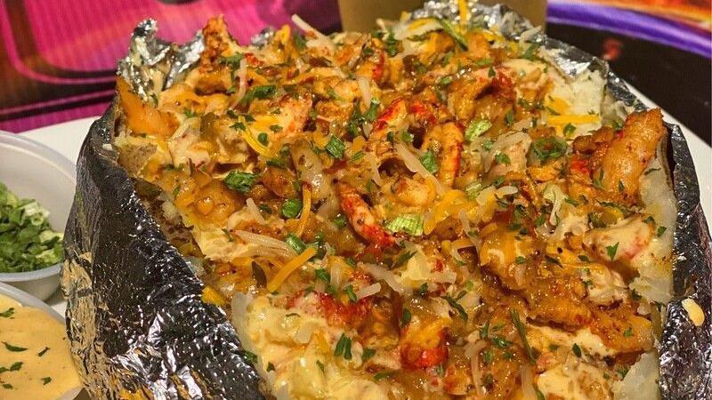 Loaded Seafood Baked Potato · Stuffed baked potato loaded with grilled shrimp, grilled crawfish, butter, shredded cheese, and seafood sauce.