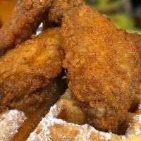 Chicken & Waffles · Four seasoned deep fried golden battered chicken wings and sweet buttered waffles.