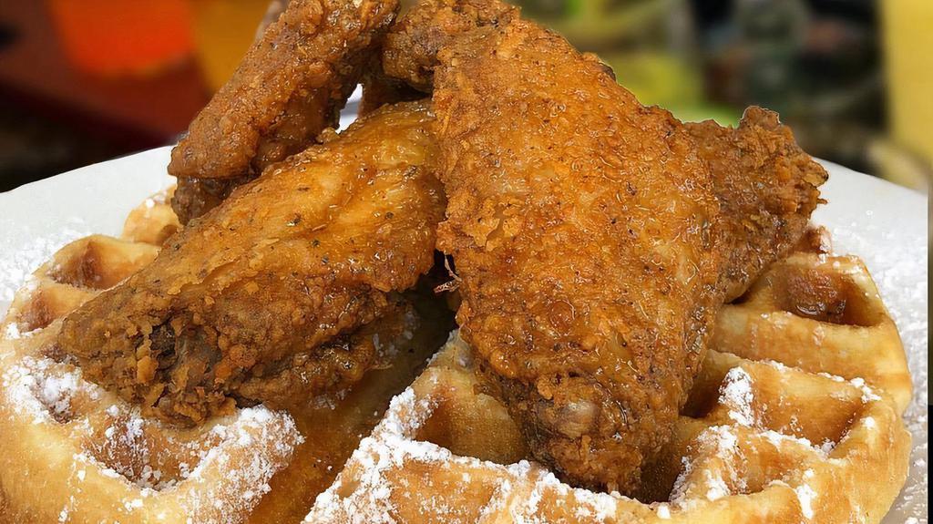 Chicken & Waffles · Four seasoned deep fried golden battered chicken wings and sweet buttered waffles.