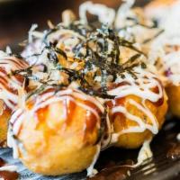 Takoyaki · Five pieces. Baked octopus ball with mayo and eel sauce, dried fish flakes on top.