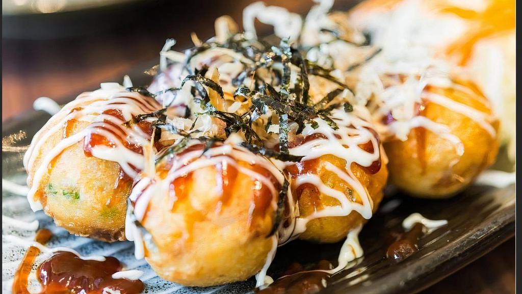 Takoyaki · Five pieces. Baked octopus ball with mayo and eel sauce, dried fish flakes on top.