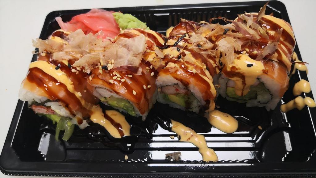 Yammy Yammy Roll · Imitation crab, avocado, cucumber, cream cheese wrapped with salmon on top, drizzled with eel sauce, spicy mayo, and bonito flakes.