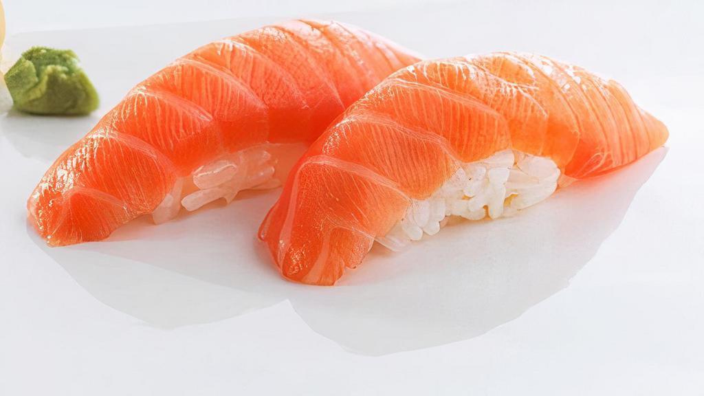Scottish Salmon (2 Pieces) · Scottish, sushi rice topped with slices of raw fish.