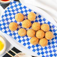 Sesame Balls · Deep fried spherical pastry with chewy insides and sweet red beans.