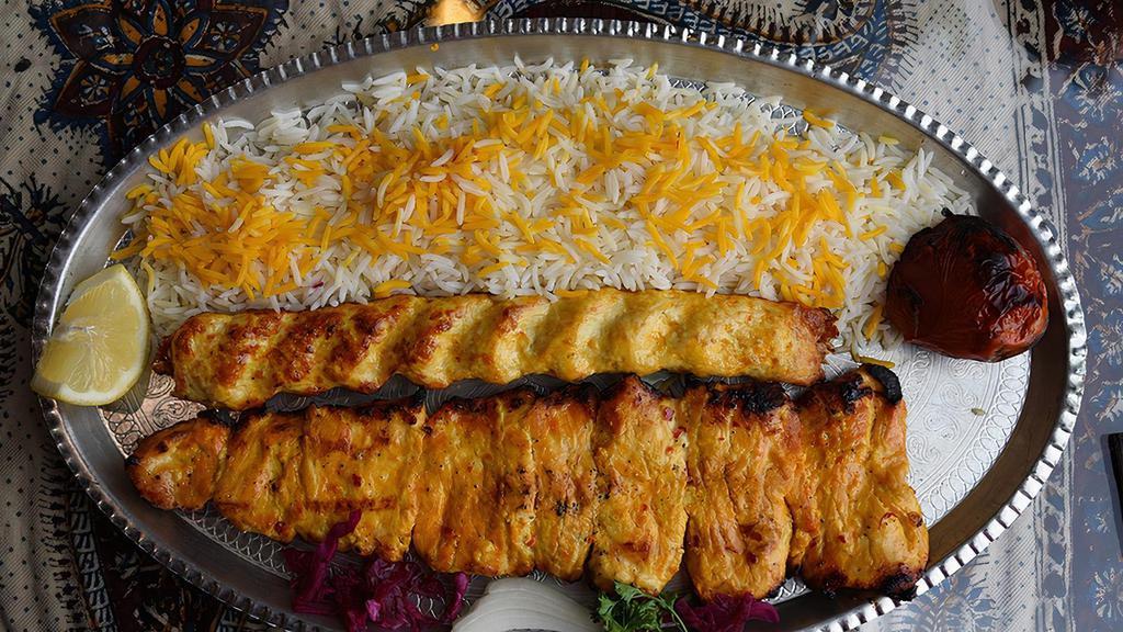 Chicken Sultani · Gluten free. Combination of 1 skewer of charbroiled marinated chicken tenderloin and 1 skewer of juicy ground chicken kabob. Served over fluffy saffron rice, sides of onions and grilled tomatoes.