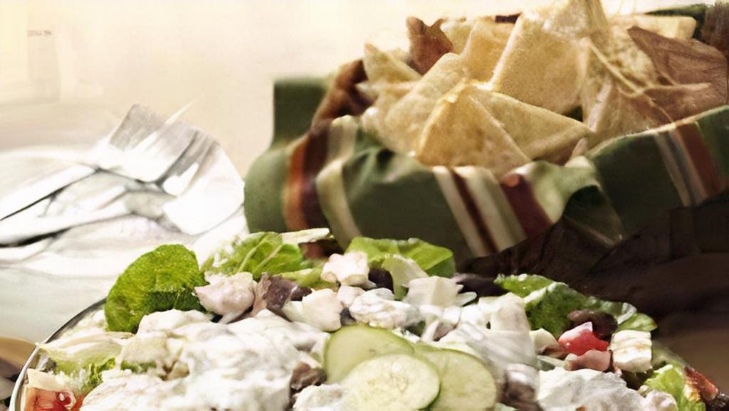 Chicken Shawarma Salad · Combination of shredded iceberg lettuce, tomatoes, cucumbers, onions, tzatziki, feta cheese and olives.