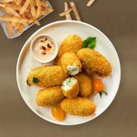 Spicy Poppers · (7 pieces) Fresh jalapenos coated in cream cheese and fried until golden brown.