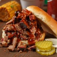 Bbq Sandwiches · Enjoy our slow smoked brisket sliced or chopped on a bun topped with BBQ sauce, pickles & on...