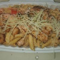 Cajun Pasta Deluxe · Our signature Cajun Chicken Pasta layered with grilled Salmon Chunks, grilled Shrimp, and to...
