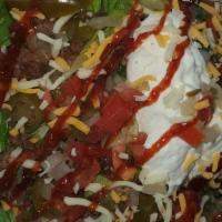 Nacho Supreme · (Choice of BBQ or buffalo nachos with extra cheese, lettuce, jalapeños, pico, sour cream, et...