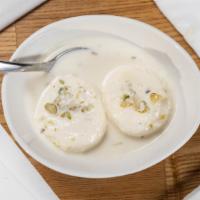 Rasmalai · Soft cheese / Paneer balls drenched in thick milk sprinkled with grated dried fruits.
