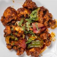 Cauliflower Manchurian · Cauliflower florets dipped in spiced batter, deep-fried and sautéed with chopped onion, bell...