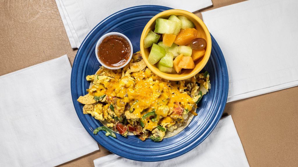 Migas Mexican Scramble · Two eggs scrambled with pork sausage, fried tortilla chips, jalapeño, onions, tomatoes, and cheddar cheese, Served with two warm corn tortillas and potatoes. A spicy breakfast treat!