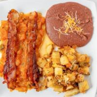Huevos Rancheros · Two eggs with bacon and spicy ranchero sauce on top. Served with refried beans and potatoes.