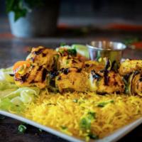 Chicken Kabob · Two skewers of chargrilled chicken kabobs with bell peppers and onions.