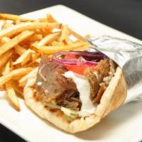 Gyro Sandwich · Savory beef and lamb slices rolled in a Greek pita with lettuce, tomatoes, onions and our ta...