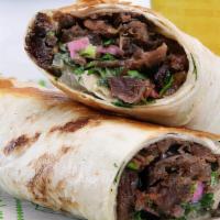 Beef Shawarma · Rotisserie beef slices rolled in a pita with lettuce, tomatoes, onions, pickles and our deli...