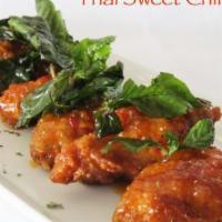 Chicken Wings · Fried chicken wings served with Thai street sweet chili sauce & topped with fried sweet basil.