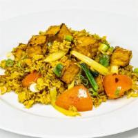Vegan Yellow Tofu Fried Rice · Fried rice with tofu, curry powder, onions, and tomatoes. No Eggs (No Meat Products)