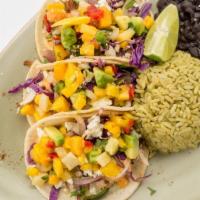 Tacos De Pescado · 3 flour tortillas with grilled tilapia with tomatoes and lettuce. Served with Mexican rice o...