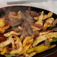 Fajitas De Res (Parrilada)  · Two pieces. Steak with your choice of flour or corn tortillas. Served with rice and beans.