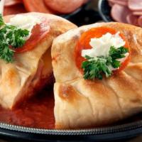 Meat Calzone · Baked calzone stuffed with ham, pepperoni, ricotta, and mozzarella cheese.