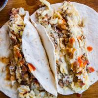 Chorizo Taco · With eggs, Swiss cheese, potato and chorizo on a flour tortilla and served with a side of ho...