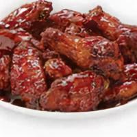 Smoky Bbq Bone-In Wings · Our traditional bone-in wings oven roasted, and then tossed in smoky BBQ sauce. An amazing c...