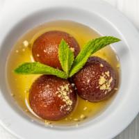 Gulab Jamun · Sweet pastry balls served warm in flavored syrup.