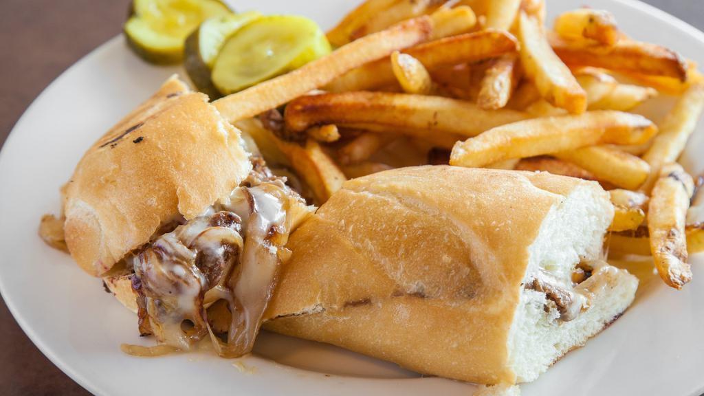 Grilled Philly Steak Sandwich · Grilled tenderloin steak, caramelized onions, mozzarella cheese, green bell peppers and mushrooms on a baguette. Served with homemade fries.