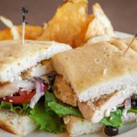 Greek Chicken Sandwich · Grilled chicken breast, feta cheese, tomatoes, olives, red onions, cucumbers, lettuce and ol...
