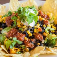 Sante Fe Salad · Fresh romaine lettuce, chopped tomatoes, black olives, red onions, black beans, corn, grated...