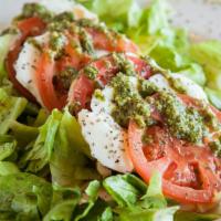Caprese Salad · Slices of buffalo mozzarella and sliced tomatoes, drizzled with extra virgin olive oil, bals...