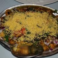 Samosa Chaat · Triangular pastries stuffed with potato and spices dipped in a chickpeas-based curry with ch...