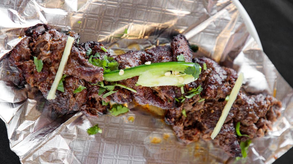 Bihari Kabab · A tenderized skirt-cut strip of beef marinated in traditional spices and grilled.