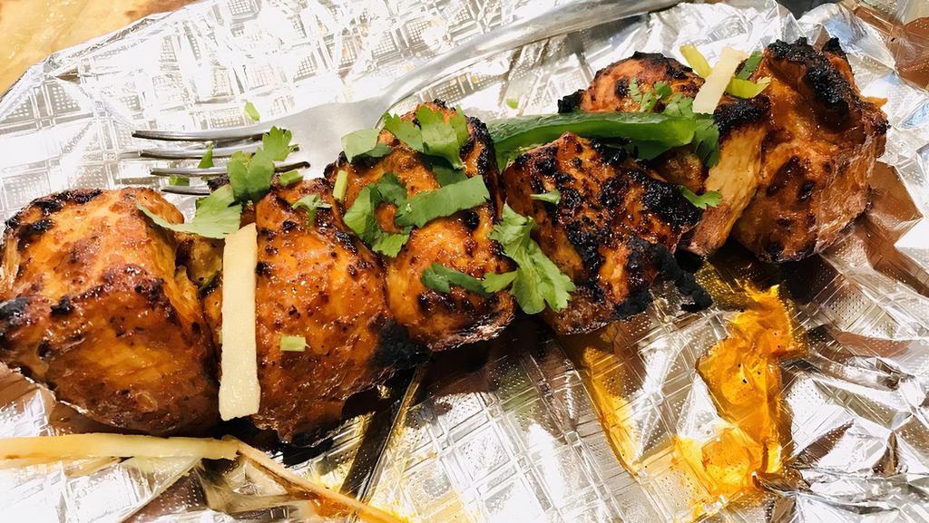 Chicken Boti · Grilled boneless chicken marinated in tandoori spices. There are six pieces in a plate.