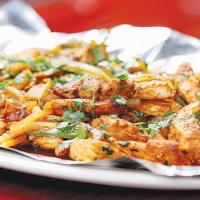 Tawa Chicken · Strips of marinated chicken sautéed in a tawa with onions, tomatoes, coriander, jalapeños, a...