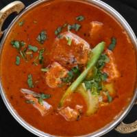 Butter Chicken · Boneless tandoori chicken cooked with onions, garlic ginger, tomatoes, cream, cashew nuts, a...