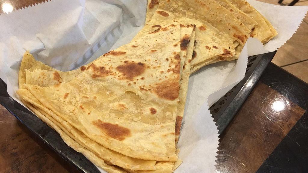Roti · Our signature home-style flat bread made with a mix of wheat and flour and shallow fried without oil on a flat tawa.