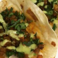Carnitas Taco  · Tender pork shredded meat with cilantro and onions