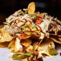 Cowboy Nachos · Potato chips covered with pulled pork, queso cheese, pickled jalapenos, chopped tomatoes, di...