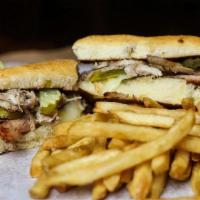 Creekwood Cubano · Roasted pork, sliced ham, Swiss cheese, pickle strips and creole mustard on a jalapeno chedd...